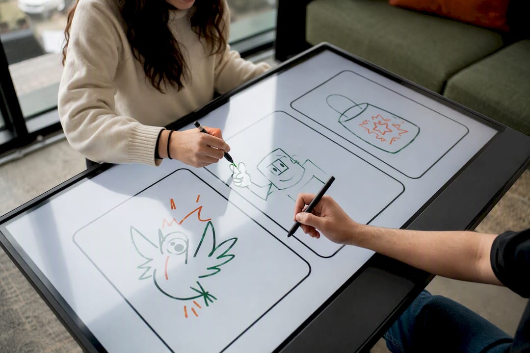 Hands exchanging stylus for relay drawing
