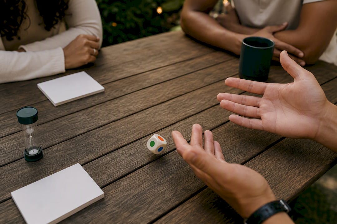 Hand rolling dice on wooden table
